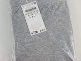 a close up of a pair of grey pants on a white surface
