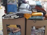 a cardboard box filled with clothes and other items