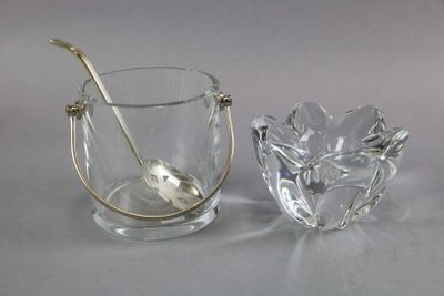 a glass cup with a spoon in it next to a glass bowl with a spoon in it