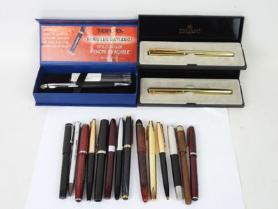 a lot of pens and a pen case on the table