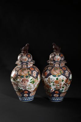 pair of chinese vases with flowers and birds on them against a black background