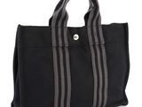black canvas tote bag with grey stripes on the side