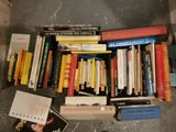 a lot of books that are sitting on the floor