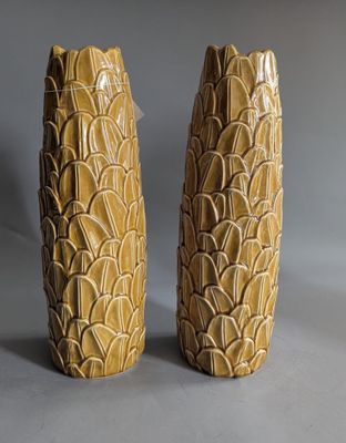 pair of yellow ceramic vases on grey background with grey background
