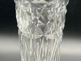 a glass vase with a label on it on a table