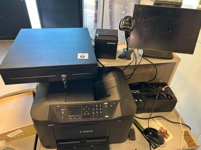 a printer sitting on top of a desk next to a monitor