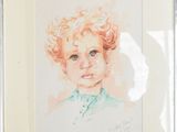 painting of a child with curly hair in a frame on a table