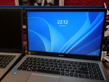 two laptops sitting side by side on a table