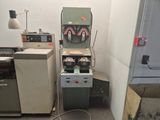 a machine that is sitting next to a refrigerator in a room