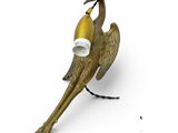 brass figurine of a bird with a banana in its beak