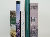 three books that are sitting next to each other on a table