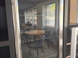an image of a glass door refrigerator in a kitchen