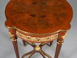 an image of a small table with a wooden top and gold trimming