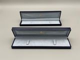 a pair of black and white jewelry boxes sitting on top of a table