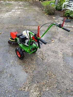 a small tractor that is parked in the driveway