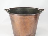 an old copper bucket with handles on a white background