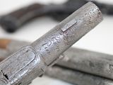 a close up of a gun and a pair of scissors
