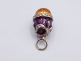 an image of a purple and orange glass bead with a snake on it