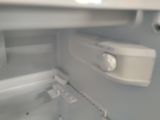 a close up of the inside of an empty refrigerator