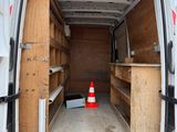 a white van with wooden shelves in the back of it