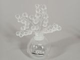 a glass vase with a bunch of small white flowers in it