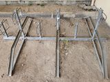 a bike rack that is in the middle of the ground