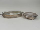 two silverplated serving dishes with lids and handles