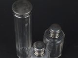 three salt and pepper shakers sitting on a black surface