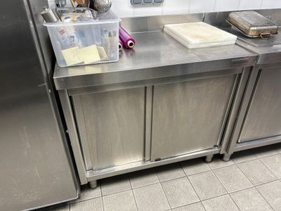 a stainless steel counter top in a kitchen with stainless steel cabinets