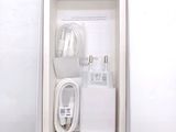 a white box with a charger and a cable in it
