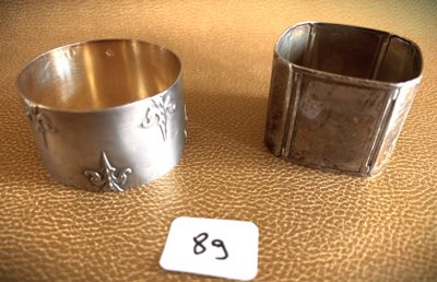 pair of silverplated napkin holders with numbers on them on a table