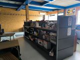 a refrigerator in the middle of a room with a lot of books on the shelves