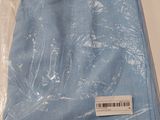 a bag of blue cloth sitting on a table next to a pair of scissors