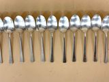 six cuillères en argent alignées en rang sur une table
