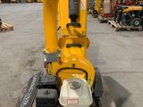 a yellow machine sitting on top of a pallet in a warehouse