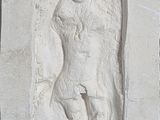 a sculpture of a woman on the wall of a building