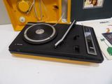 a record player sitting on top of a table next to a cd player