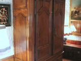a large wooden cabinet in the corner of a room