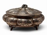 a silver plate with a lid and a handle on a stand