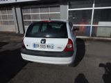a small white car parked in front of a building