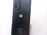 the back of a black samsung galaxy note 10 lite sitting on top of a white surface