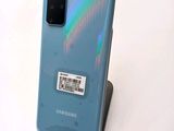 the back of a blue samsung galaxy s20 with a barcode sticker on it