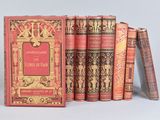 several old books sitting on top of each other on a table