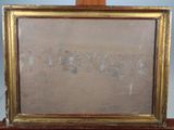 an old picture frame sitting on top of a wooden table