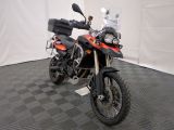a motorcycle that is parked on a checkered floor