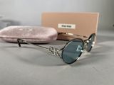 chanel sunglasses and case on a table with a pink velvet case