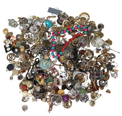 a pile of assorted jewelry on a white surface