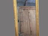 a mirror that is sitting on the floor in front of a door