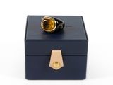 a close up of a box with a ring on top of it