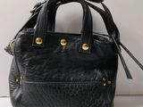 an image of a black purse on a white surface